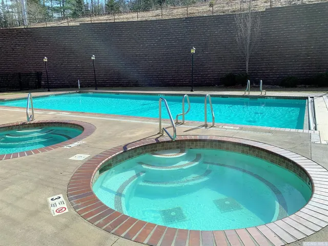 a view of a swimming pool with a yard