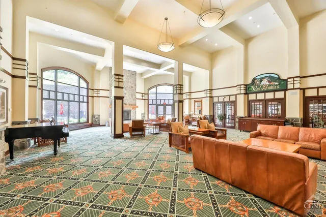 a living room with furniture fireplace and a large window