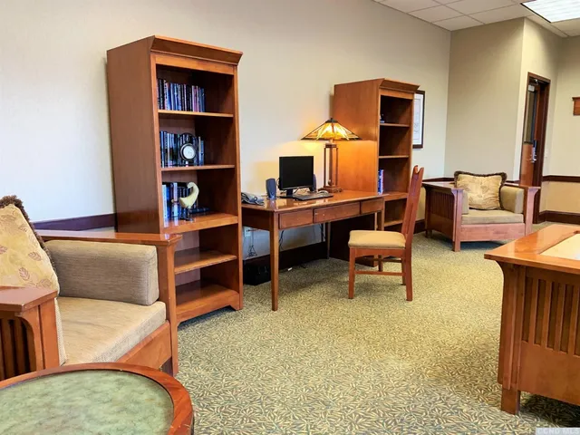 a view of a livingroom with workspace and a couch