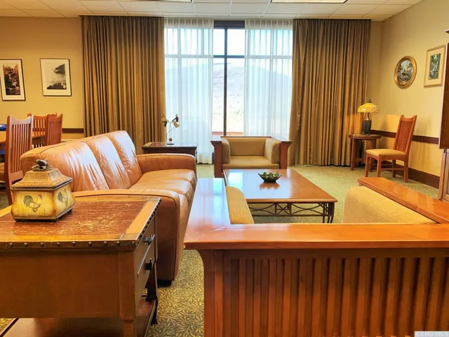 a living room with furniture and large windows