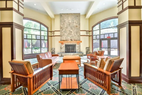 a living room with furniture a fireplace and a large window