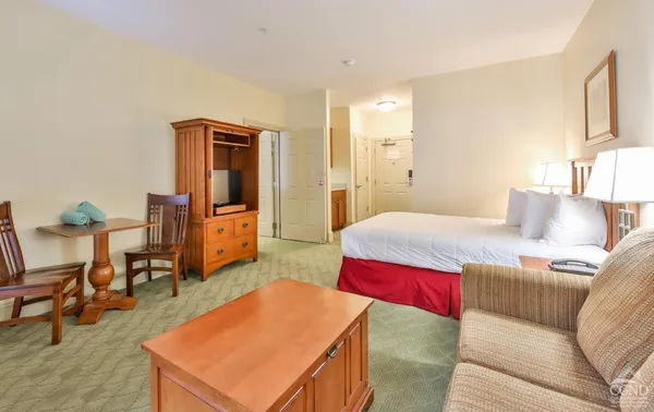 a bedroom with a bed and a table in it