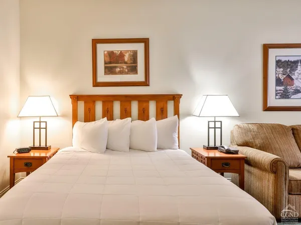 a bedroom with a bed and a lamp