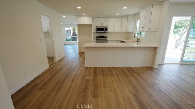 a view of kitchen with wooden floor and window