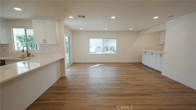 a view of a kitchen center wooden floor and a window