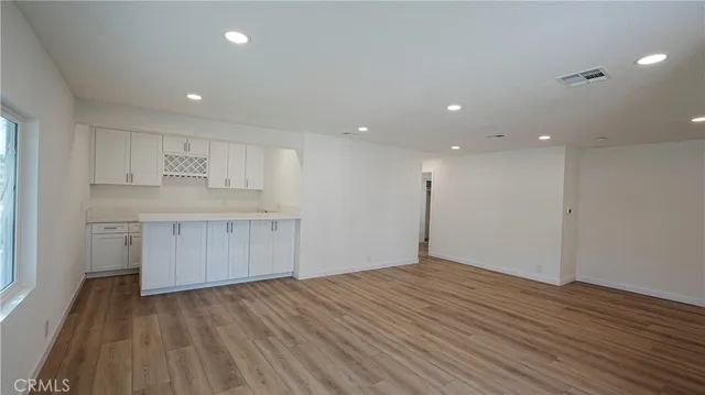 a view of kitchen with granite countertop cabinets and wooden floor