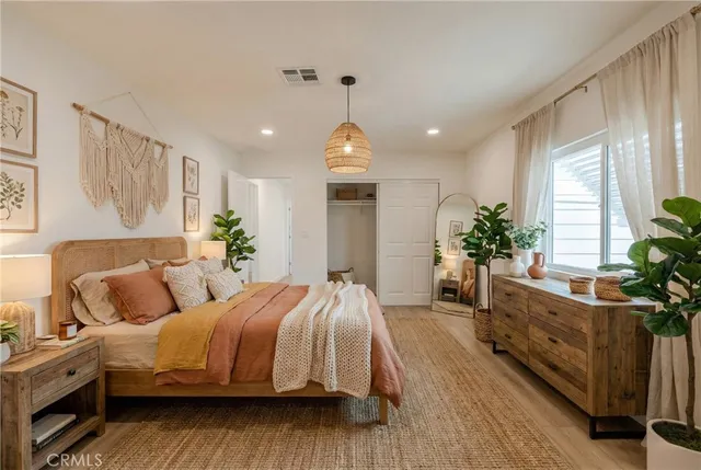 a bedroom with a bed and a potted plant