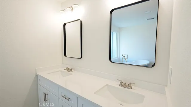a bathroom with mirror a sink and vanity