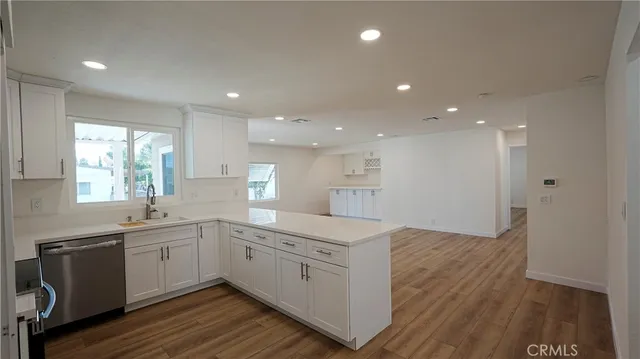 a kitchen with a sink window and cabinets
