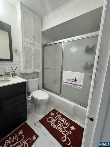 a bathroom with a toilet a sink and a mirror