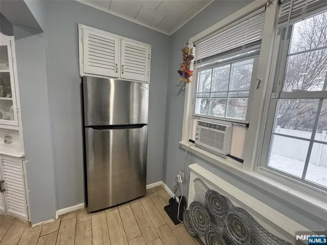 a view of a refrigerator in kitchen and wooden floor