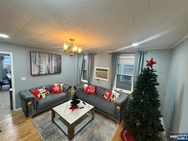 a living room with furniture and a chandelier