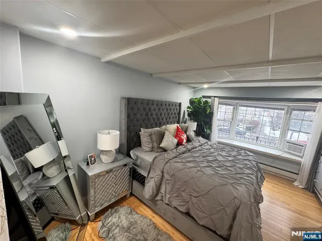 a bed sitting in a bedroom next to a window