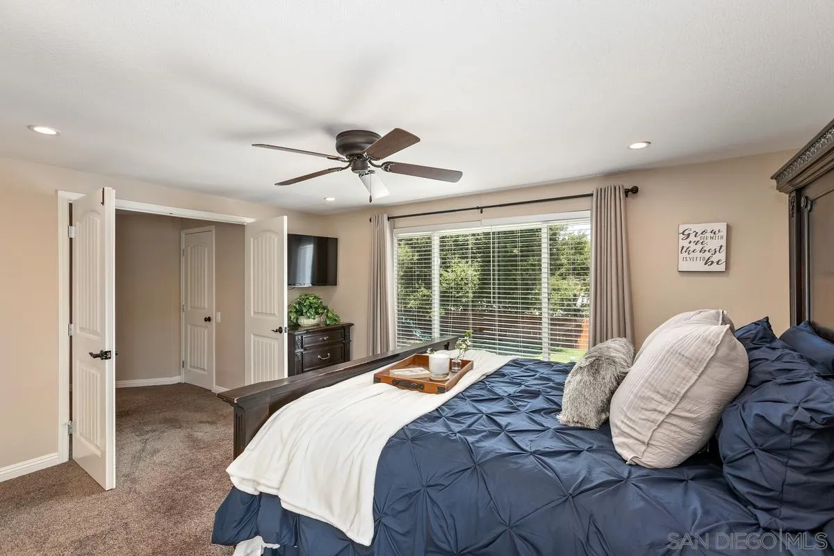 14437 Hillndale Way Poway, CA 92064 - Photo 13 of 35 a bedroom with a large bed and a large window