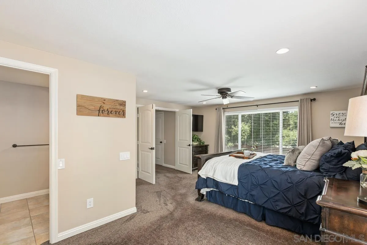 14437 Hillndale Way Poway, CA 92064 - Photo 14 of 35 a spacious bedroom with a bed and large windows