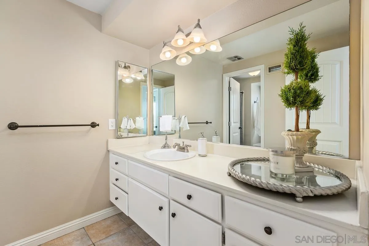 14437 Hillndale Way Poway, CA 92064 - Photo 15 of 35 a bathroom with a sink and a mirror