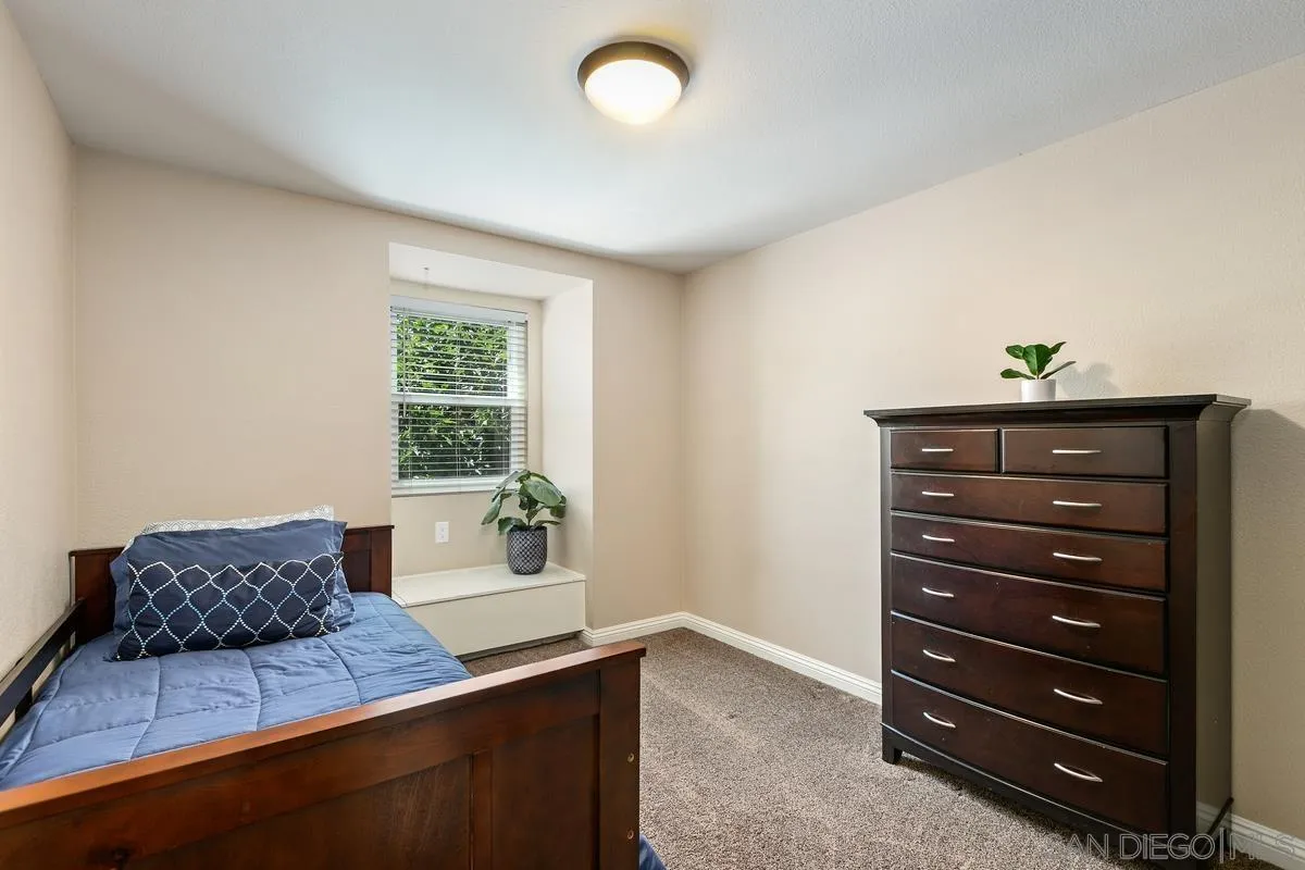 14437 Hillndale Way Poway, CA 92064 - Photo 17 of 35 a room with a dresser and a window
