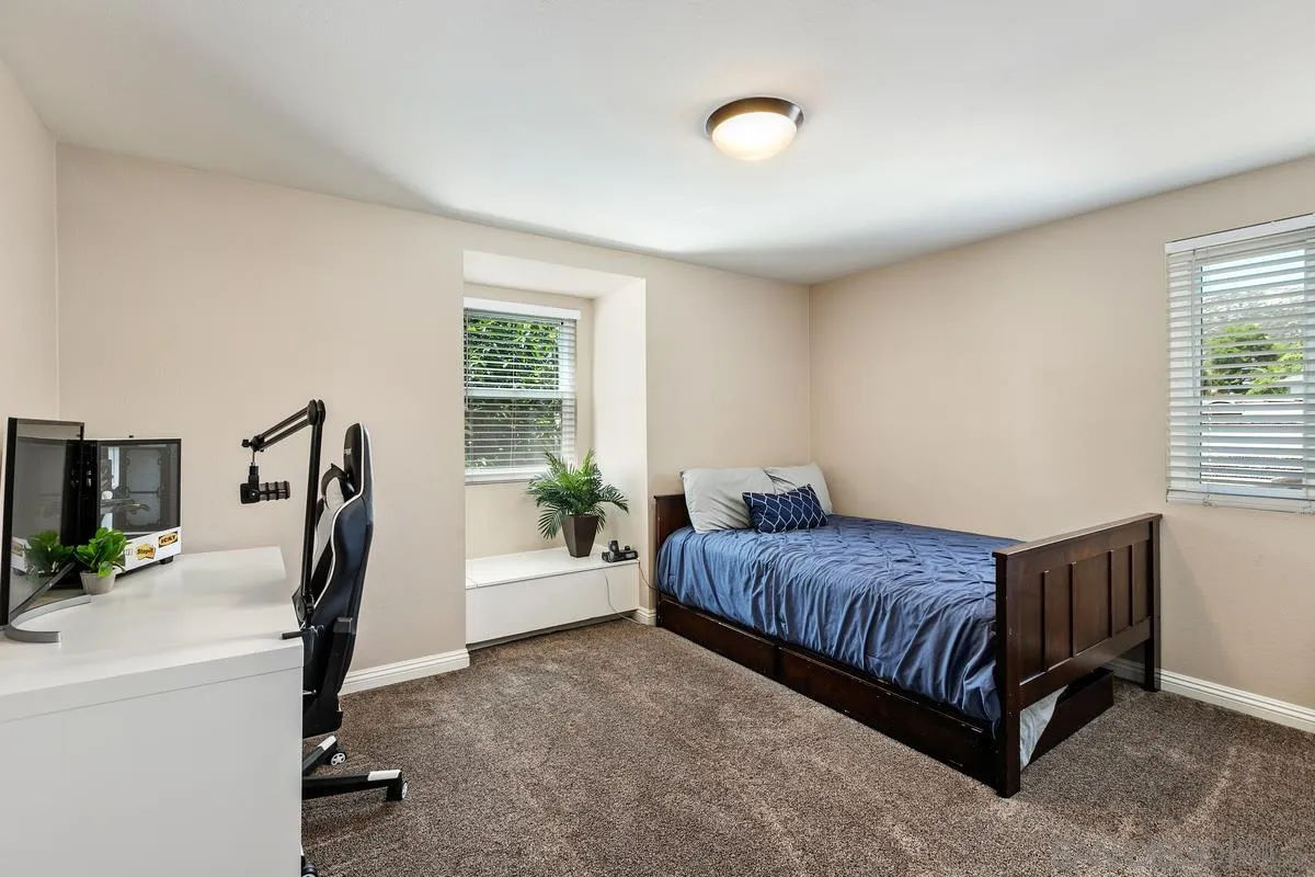 14437 Hillndale Way Poway, CA 92064 - Photo 21 of 35 a living room with a bed furniture and a potted plant