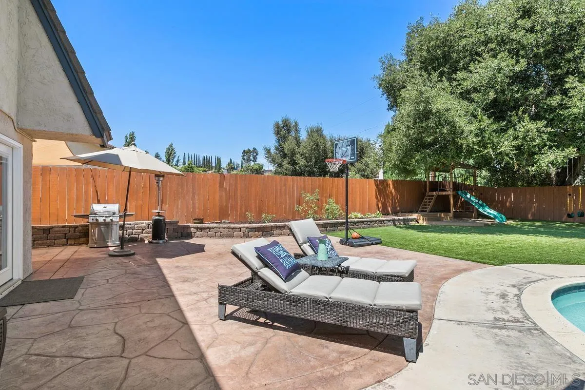 14437 Hillndale Way Poway, CA 92064 - Photo 24 of 35 a view of a patio with couches and a table and chairs with wooden fence