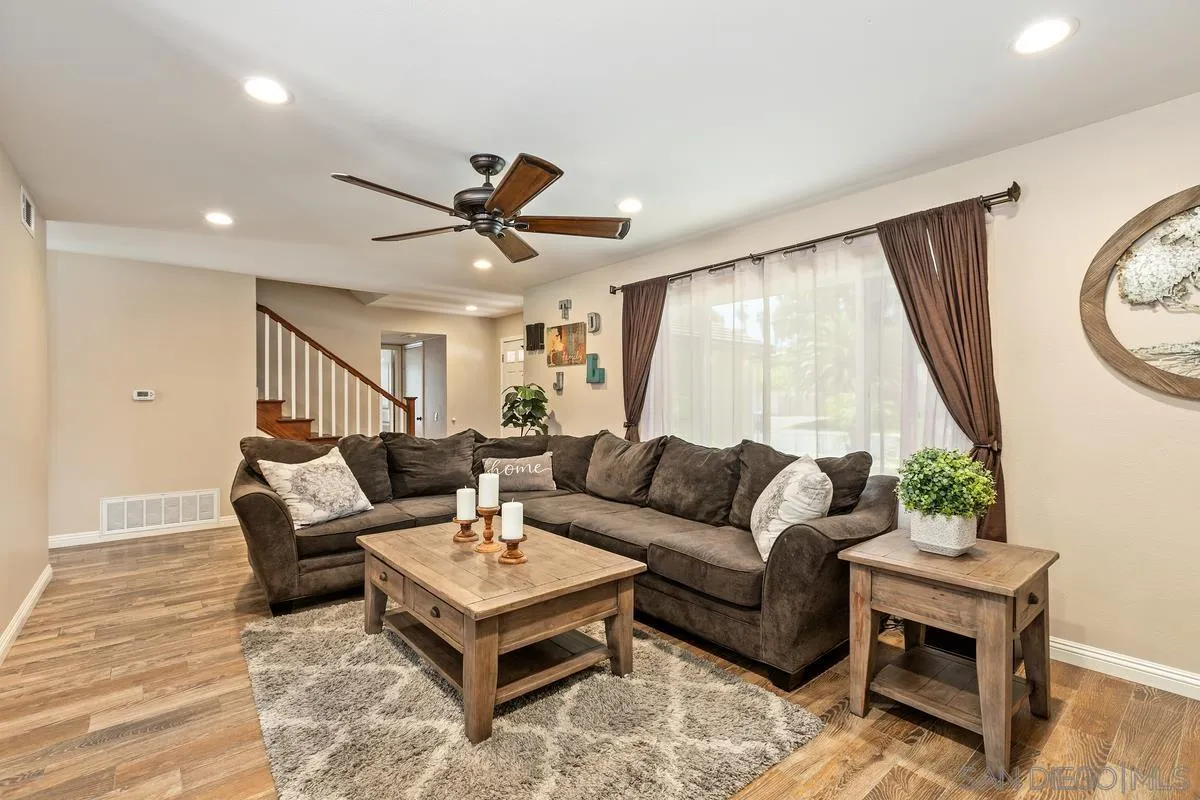 14437 Hillndale Way Poway, CA 92064 - Photo 4 of 35 a living room with furniture a large window and a ceiling fan