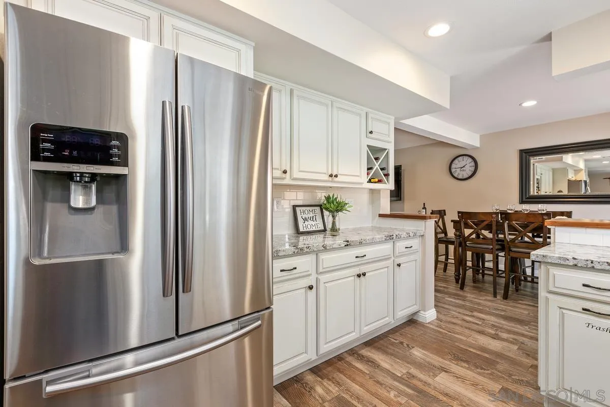 14437 Hillndale Way Poway, CA 92064 - Photo 9 of 35 a kitchen with stainless steel appliances a refrigerator sink and cabinets