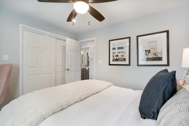 a bedroom with a large bed and a chandelier