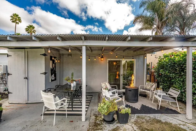a view of a patio with table and chairs and potted plants