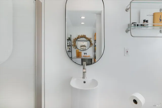 a bathroom with a toilet a sink and mirror