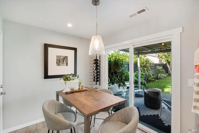 a dining room with furniture a window and a chandelier