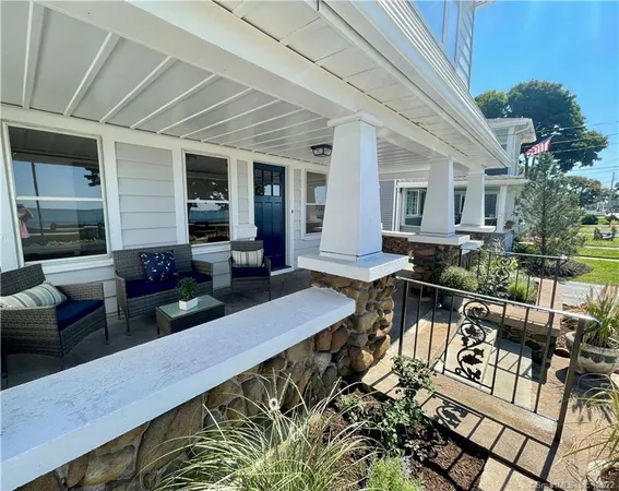 a view of a patio with couches chairs and potted plants
