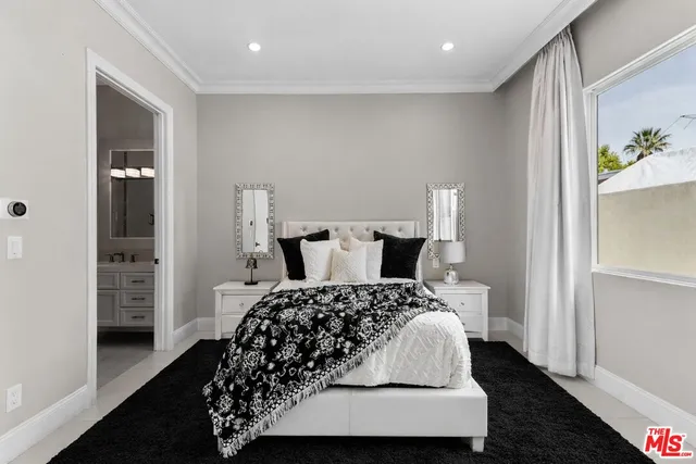 a bathroom with a granite countertop sink a mirror and a shower