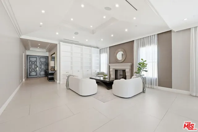 a large kitchen with kitchen island granite countertop lots of white cabinets appliances and furniture