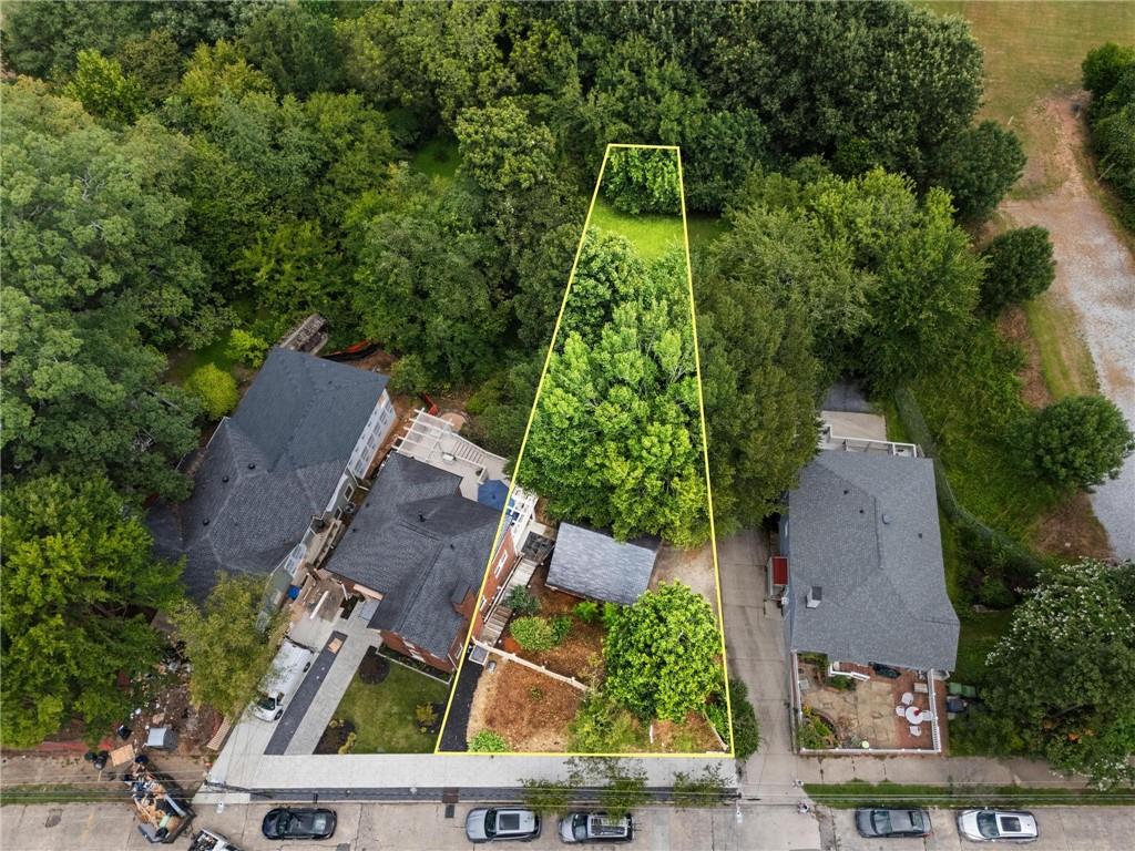 an aerial view of a house with a yard and garden