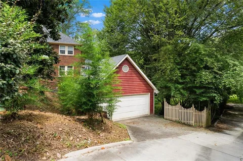 a view of a backyard with large trees