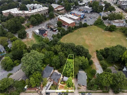 an aerial view of a residential houses with outdoor space and street view