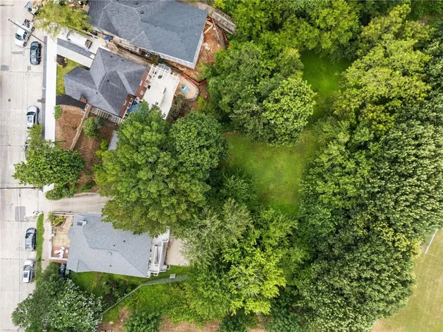 an aerial view of a house with a yard and garden space