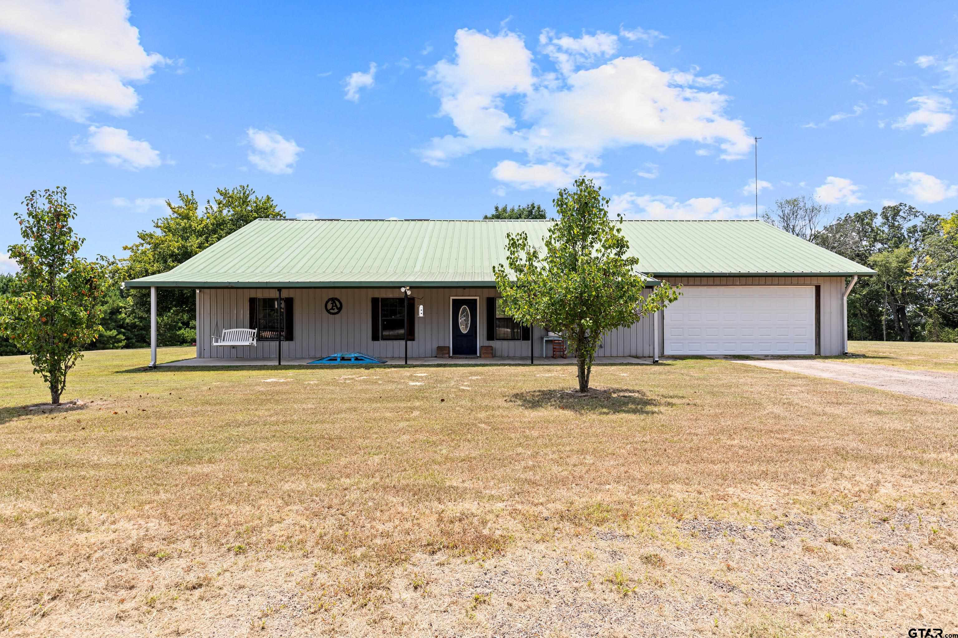 423 County Road 4306 Naples, TX 75568 - Photo 14 of 47 a front view of a house with garden