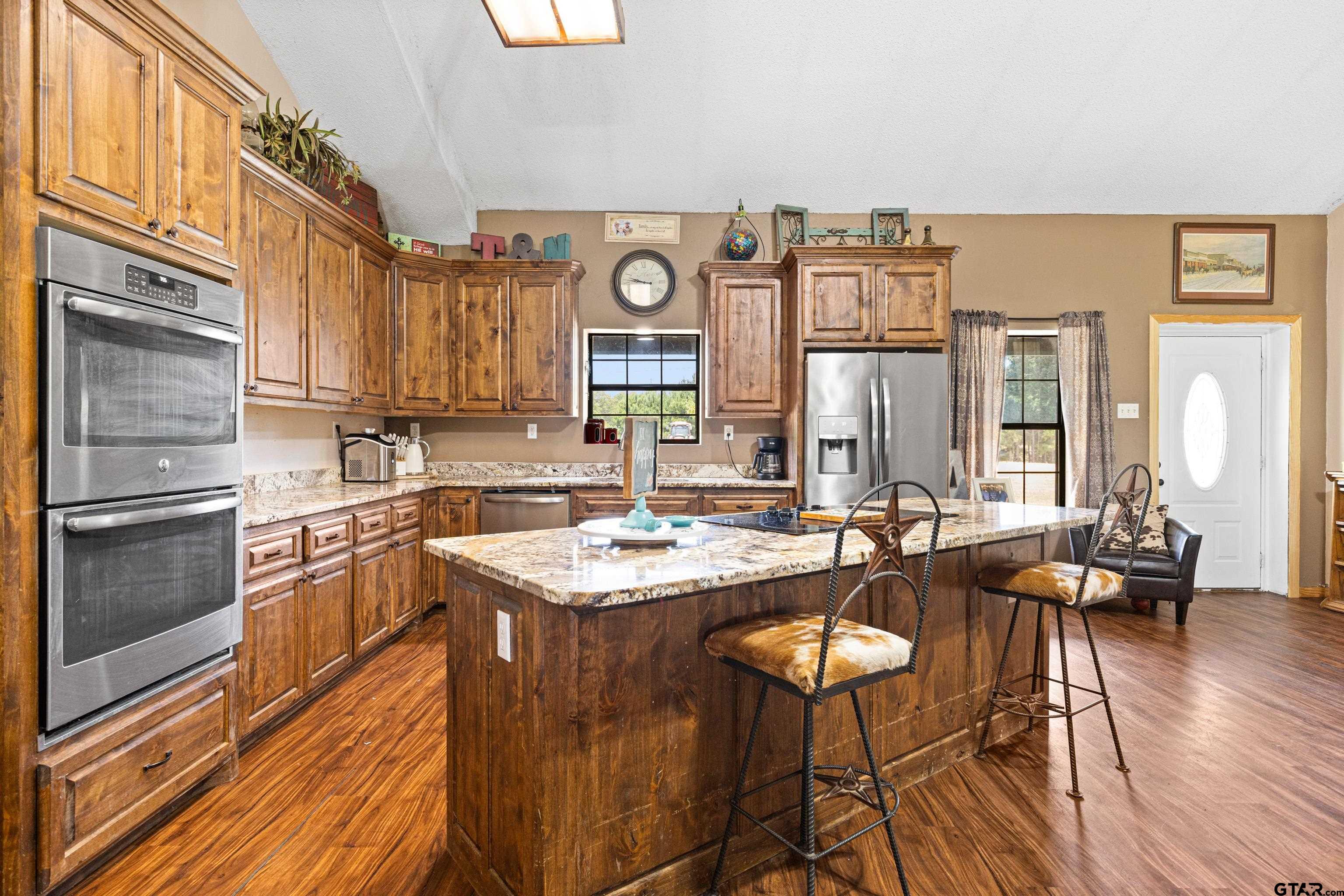 423 County Road 4306 Naples, TX 75568 - Photo 19 of 47 a kitchen with a sink stove and wooden floor