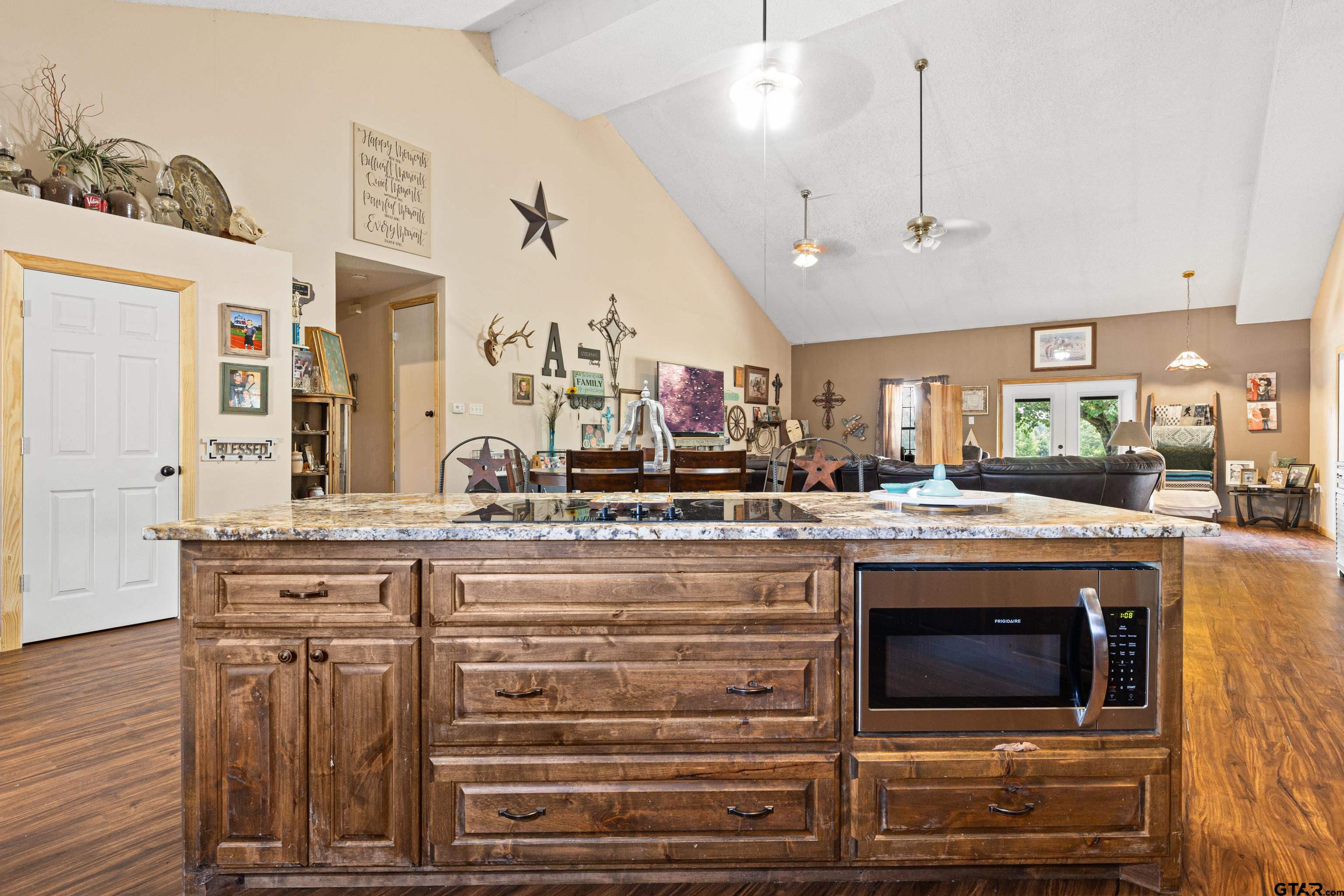 423 County Road 4306 Naples, TX 75568 - Photo 22 of 47 a view of a kitchen with kitchen island and stainless steel appliances