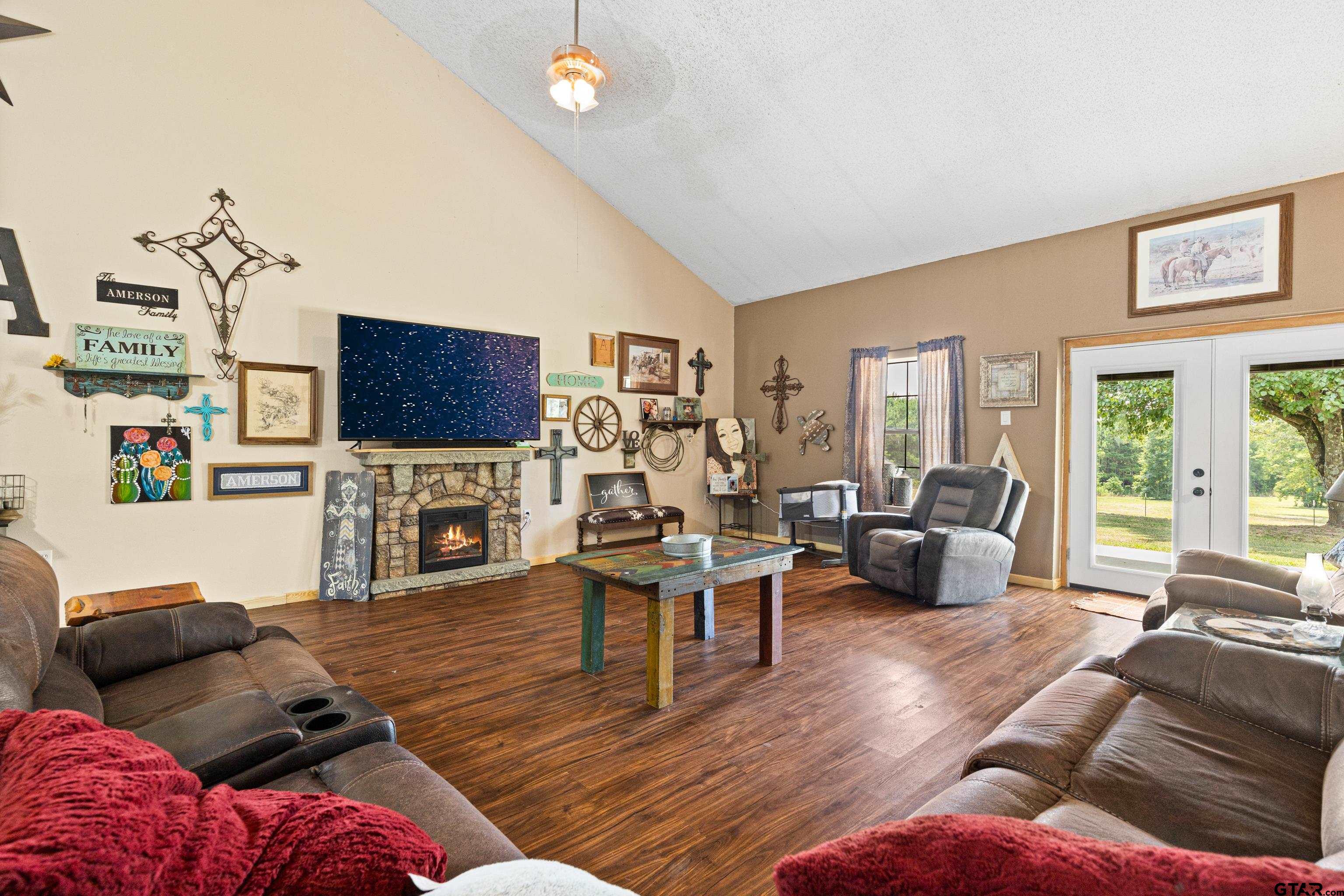 423 County Road 4306 Naples, TX 75568 - Photo 25 of 47 a living room with fireplace furniture and a flat screen tv