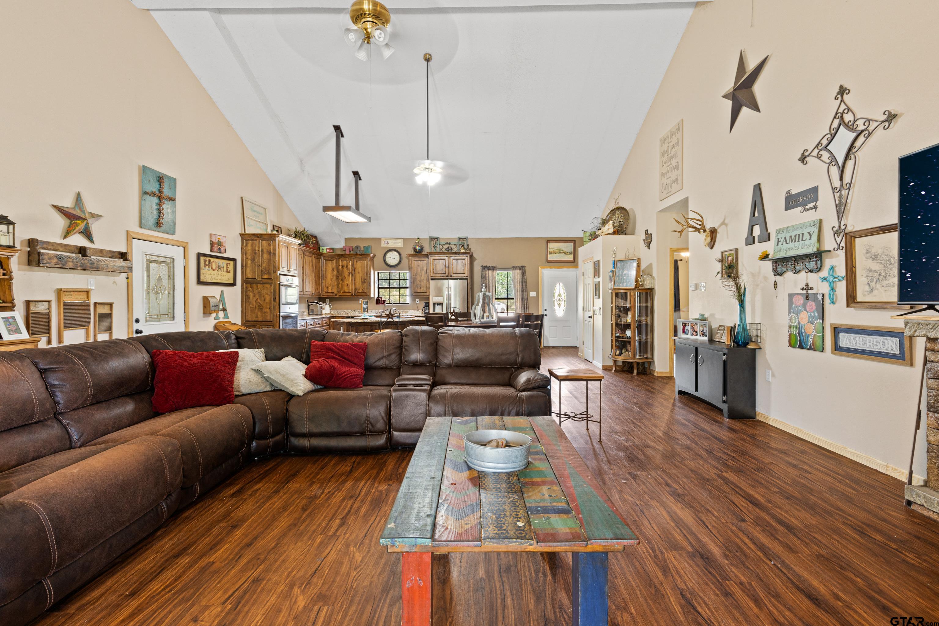 423 County Road 4306 Naples, TX 75568 - Photo 27 of 47 a living room with furniture kitchen view and a wooden floor