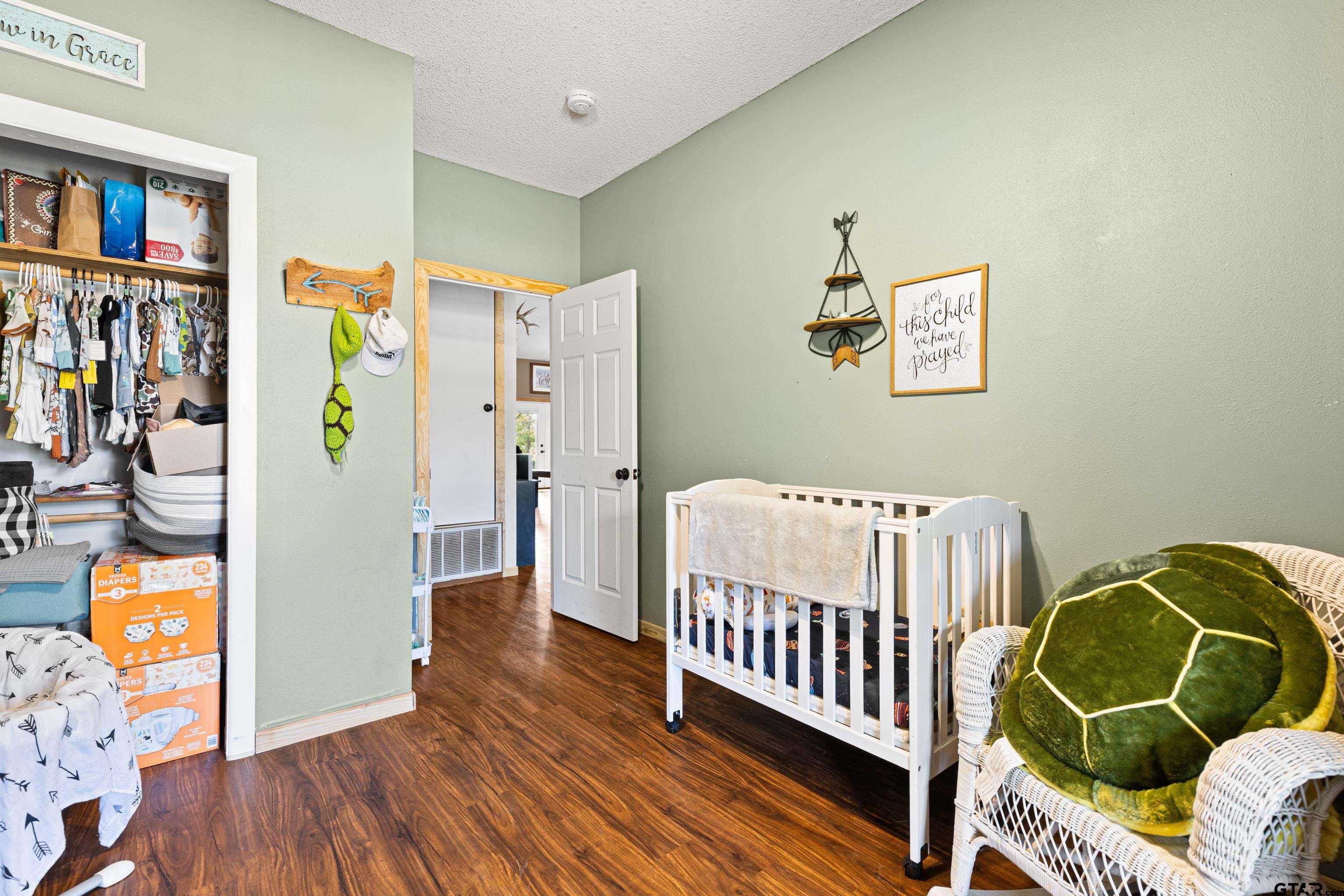423 County Road 4306 Naples, TX 75568 - Photo 29 of 47 a bedroom with furniture and a window