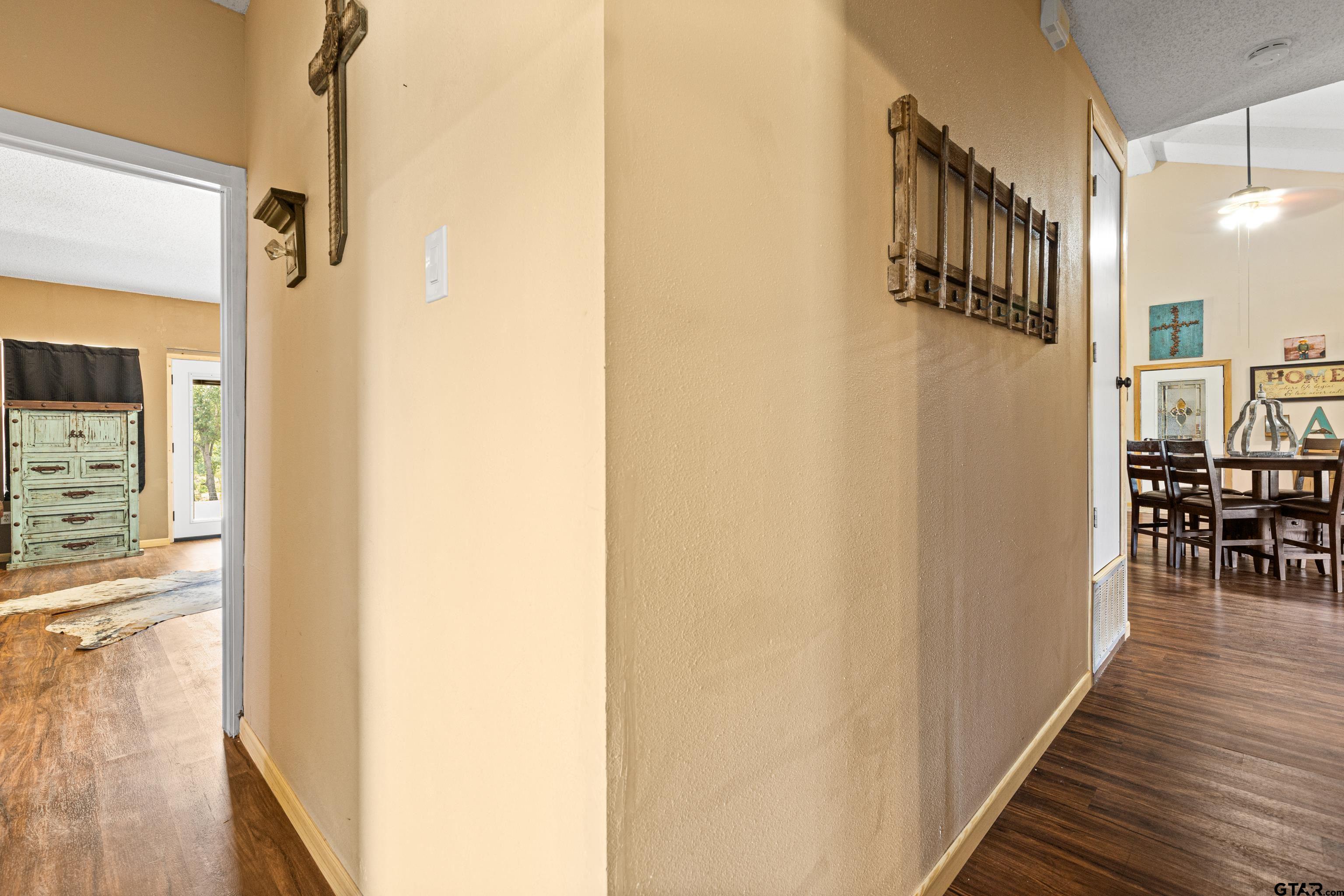 423 County Road 4306 Naples, TX 75568 - Photo 30 of 47 a view of a hallway with wooden floor and staircase