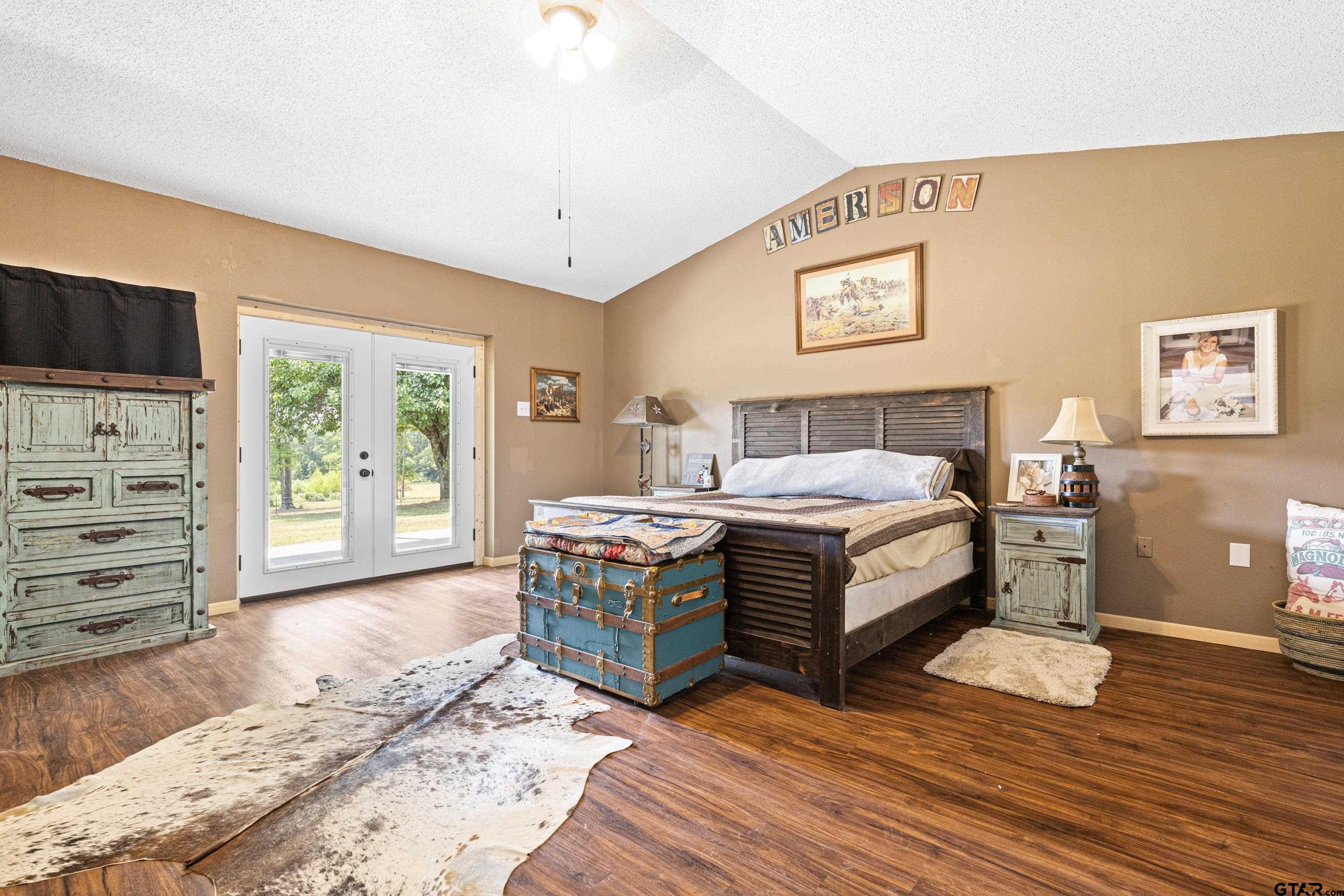 423 County Road 4306 Naples, TX 75568 - Photo 34 of 47 a spacious bedroom with a bed and a flat screen tv