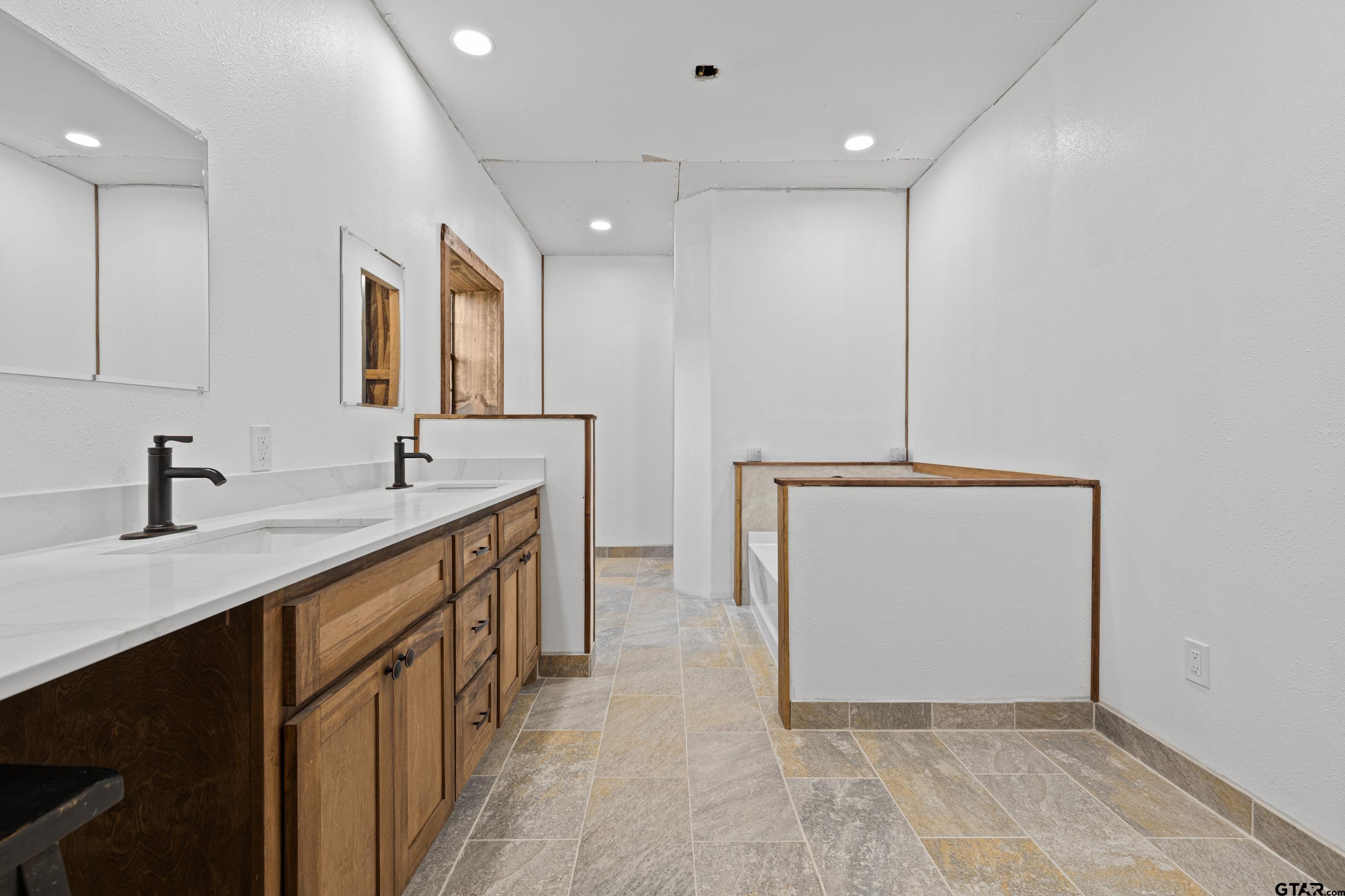 423 County Road 4306 Naples, TX 75568 - Photo 37 of 47 a bathroom with a double vanity sink and mirror