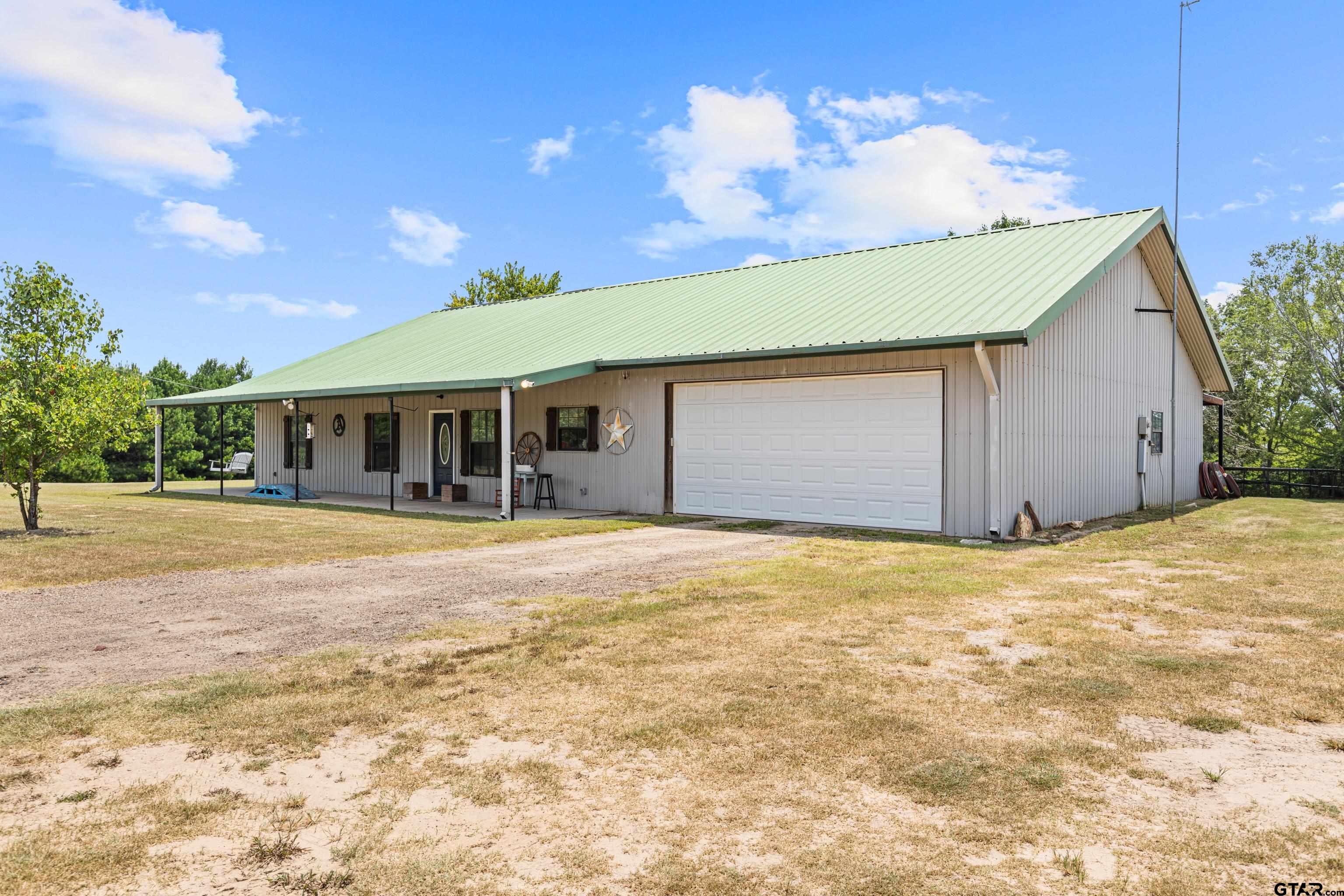423 County Road 4306 Naples, TX 75568 - Photo 5 of 47 a view of an house with backyard space and balcony