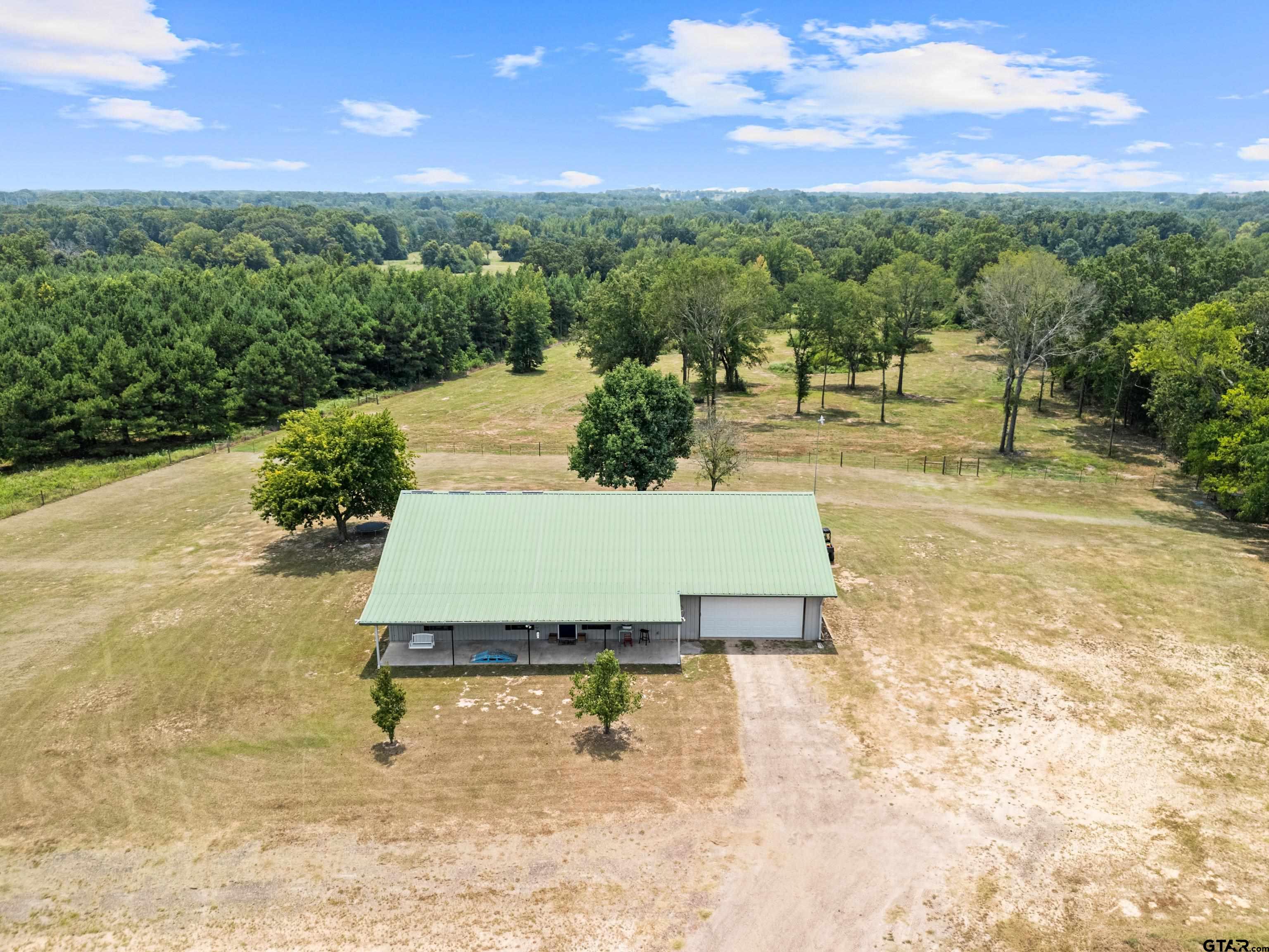423 County Road 4306 Naples, TX 75568 - Photo 7 of 47 a view of a swimming pool with a yard