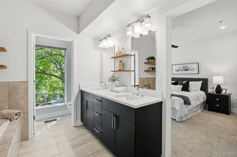 a spacious bathroom with a double vanity sink and a mirror