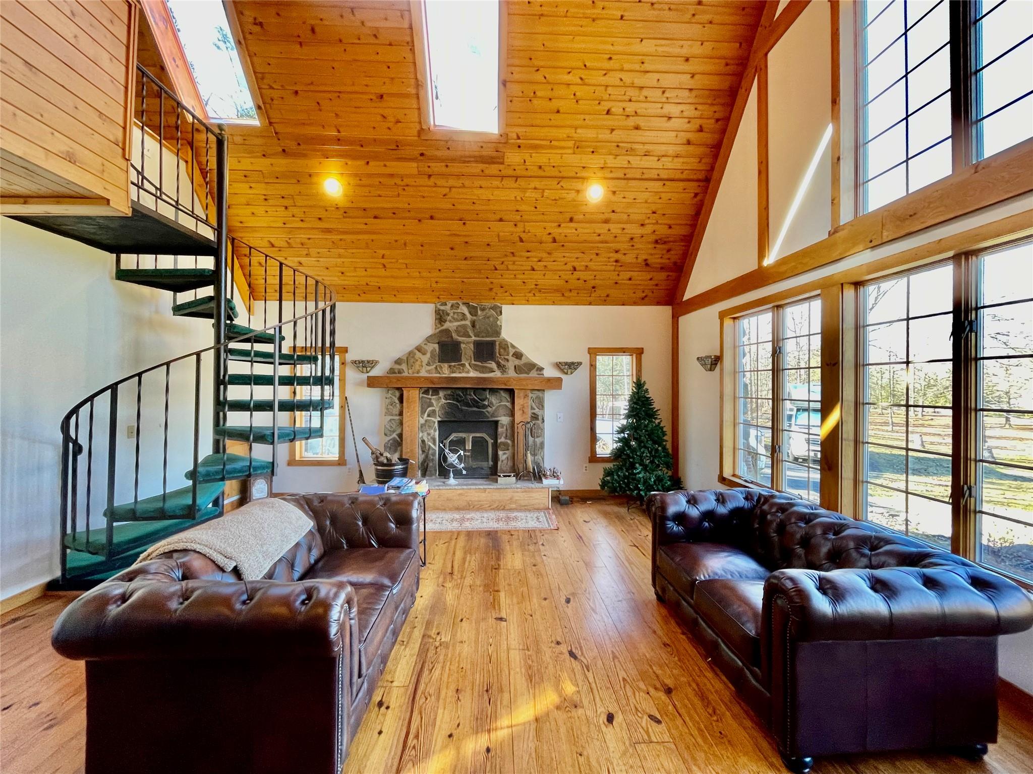 71 Saddleback Ridge Wallkill, NY 12589 - Photo 6 of 39 Living area with high vaulted ceiling, stairway, wood ceiling, baseboards, and wood-type flooring