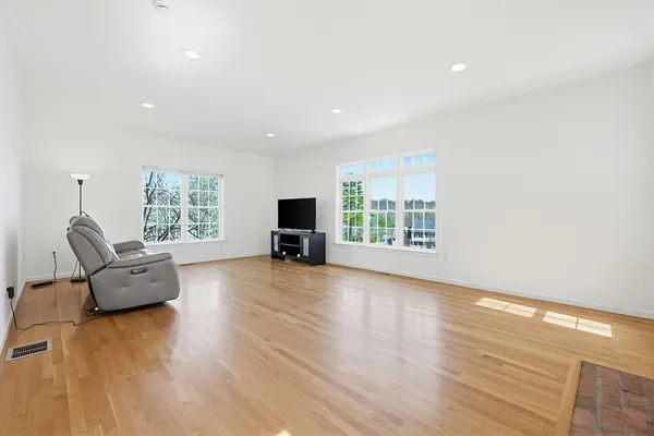 a living room with furniture window and a wooden floor